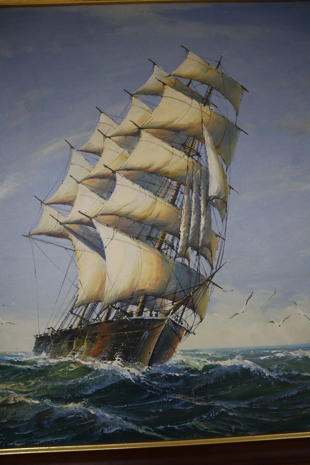 A modern oil on canvas of clipper ships at sea, 60 x 121cm